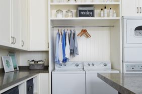 top-loading washing machine in white laundry room