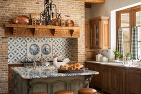 Country style tuscan kitchen with blue accents in the delft tile backsplash