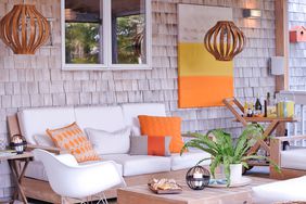 an outdoor deck covered with natural wooden beams with orange accents