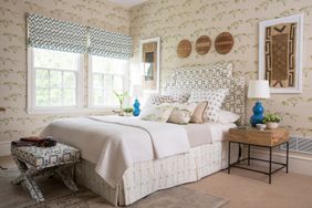 bedroom with box pleat bed skirt and pattern wallpaper