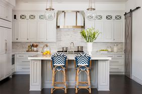 traditional kitchen with beige cabinets and blue island seating