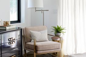 white room with beige chair and white curtains