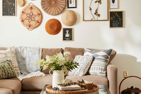 living room with fresh flowers on coffee table and framed pressings on walls