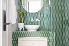 vessel sink in green tiled bathroom