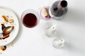 wine and wax spills on tablecloth