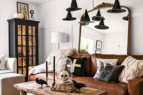 Living room with hanging witch hats and leather couch