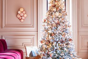 pink accented flocked tree in a living room with soft pink walls 