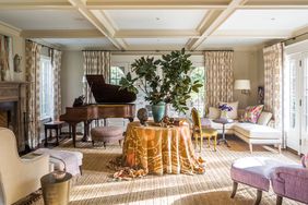 living room with piano and coffered ceiling
