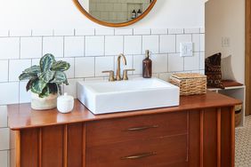 Wooden bathroom vanity with baskets and canisters