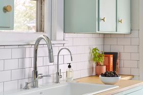 kitchen faucet sink with blue cabinets