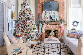 a living room with a Christmas tree and decorated mantel