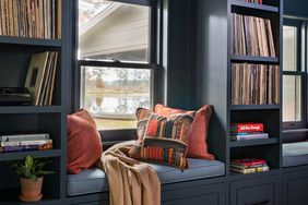 Blue wood built-ins with a window seat and cushion