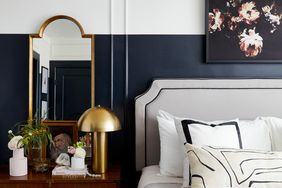 bedroom with two tone black wall and gold lamp