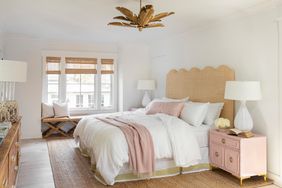 bedroom with white walls and light pink accents