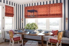 banquette with paisley fabric and striped wallpaper