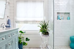 bathroom with white tile and shower corner