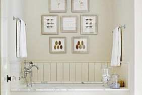 Bathtub with organized artwork in frames