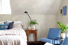 Bedroom with blue chairs and vaulted ceiling