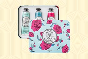 La Chatelaine Hand Cream Trio Tin Gift Set displayed on a yellow patterned background