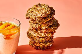 almond butter breakfast cookies with peach oats on peach colored surface