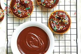 bowl of chocolate icing and chocolate iced donuts with sprinkles