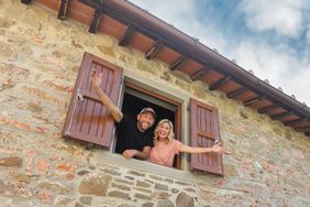 Dave and Jenny Marrs posing in window in Italian villa