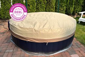 The Classic Accessories Veranda Water-Resistant 84 Inch Round Hot Tub Cover covers a hot tub on a patio