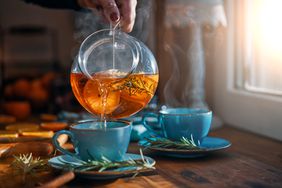 tea pot pouring into blue mug