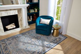 Living room with blue area rug and blue accent chair