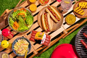 Oscar Mayer plant-based hot dogs on picnic table with other food