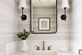 Powder room with wallpaper and floating vanity