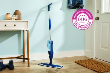 One of the best mops for hardwood floors in an entry way next to a table with a BHG Recommends badge.
