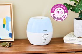 Vicks 3-in-1 Sleepy Time Humidifier Diffuser Nightlight displayed on a cabinet next to a plant with BHG recommends badge