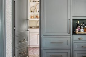 Hidden door in kitchen cabinetry into pantry