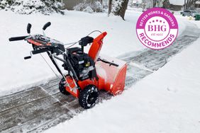 Ariens Classic 2-Stage 24 in. Snow Blower displayed on a snowy sidewalk 