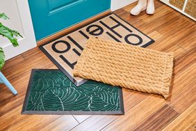 Three of the best doormats piled on each other in an entryway