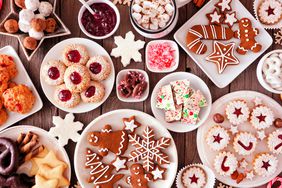 Plates with different holiday desserts like cookies and peppermint bark
