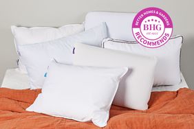 Group of six pillows on a bed