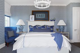 blue and white guest bedroom with patterned wallpaper