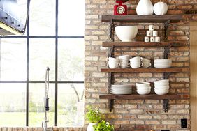 open kitchen with wood accents and brick walls