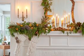 white mantel with candles and garland on it