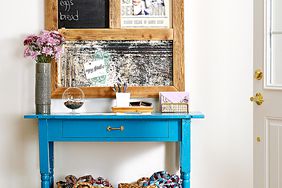 Entryway with blue table, baskets, and wall hanging