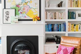 built-in shelving with decor and black fireplace