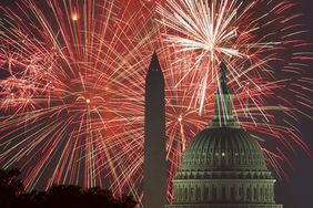 fireworks explode over the National Mall as the US Capitol (R) and National Monument