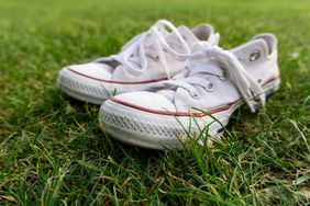 white converse shoes in grass