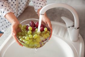 woman washing grapes