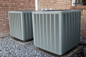 HVAC air conditioning units outdoors by brick home