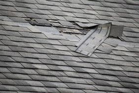 damaged roof shingles over leaking roof