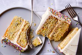 slices of yellow gluten-free cake with buttercream frosting and sprinkles