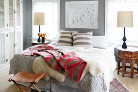 sheepskin draped over bed in gray bedroom